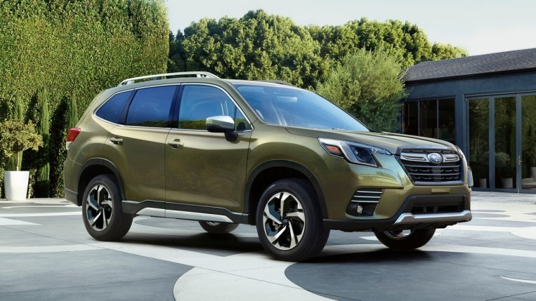 2023 Subaru Forester with green hedges in the background.