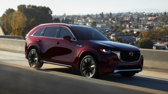 2024 Mazda CX-90 driving on the highway.