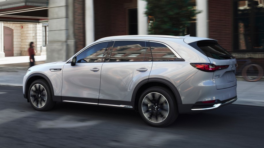 White 2024 Mazda CX-90 driving in the city.