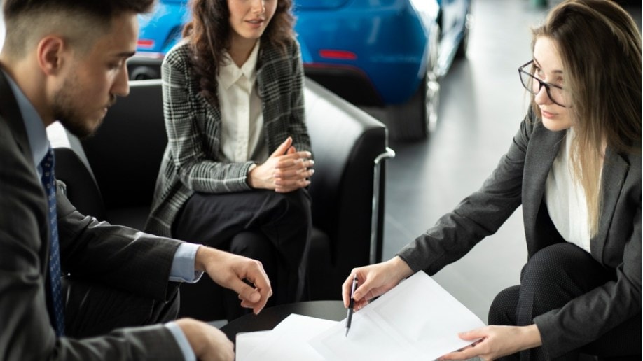 Customer and co-signer signing loan paperwwork