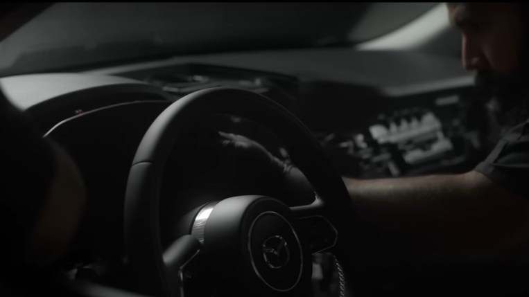 Workers assemble the dashboard of the Mazda CX-90
