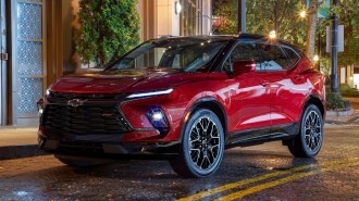 Red 2023 Chevrolet Blazer RS parked on a street at night.