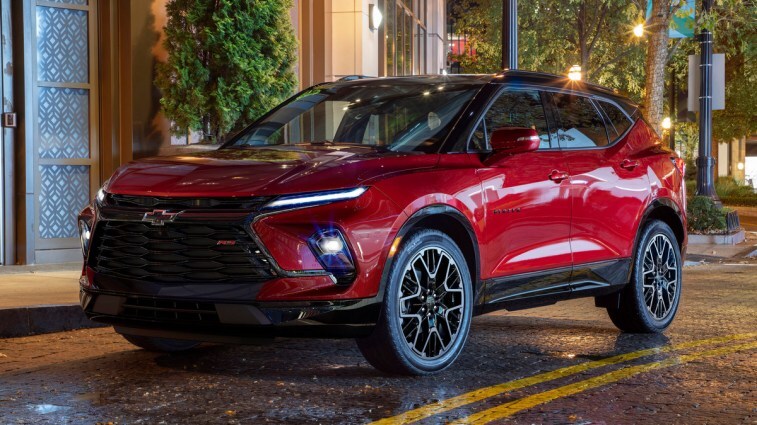 Red 2023 Chevrolet Blazer RS parked on a street at night.