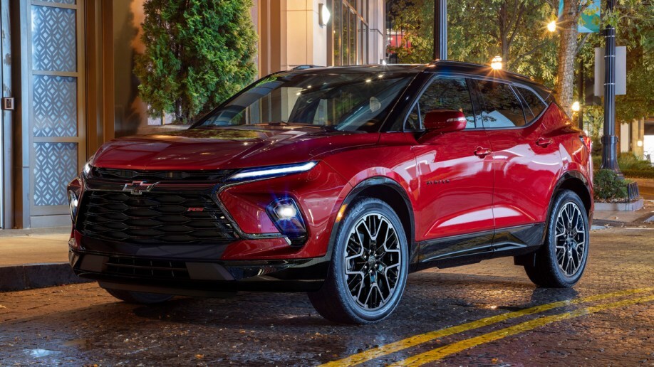 Red 2023 Chevrolet Blazer RS parked on a street at night.