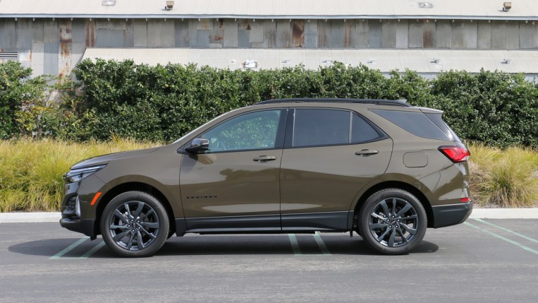 2023 Chevrolet Equinox RS near metal building.