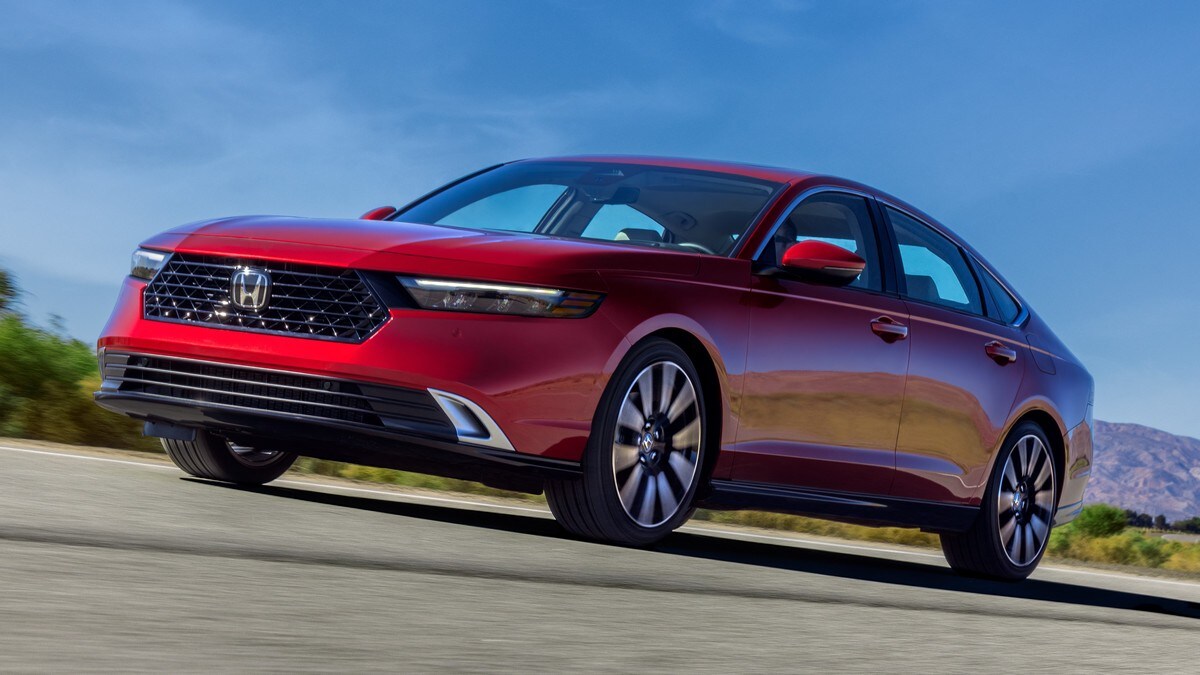 Red 2023 Honda Accord driving on highway.