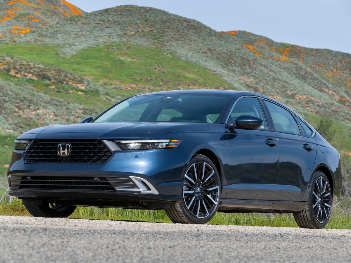 Blue 2023 Honda Accord Hybrid in near green hills.