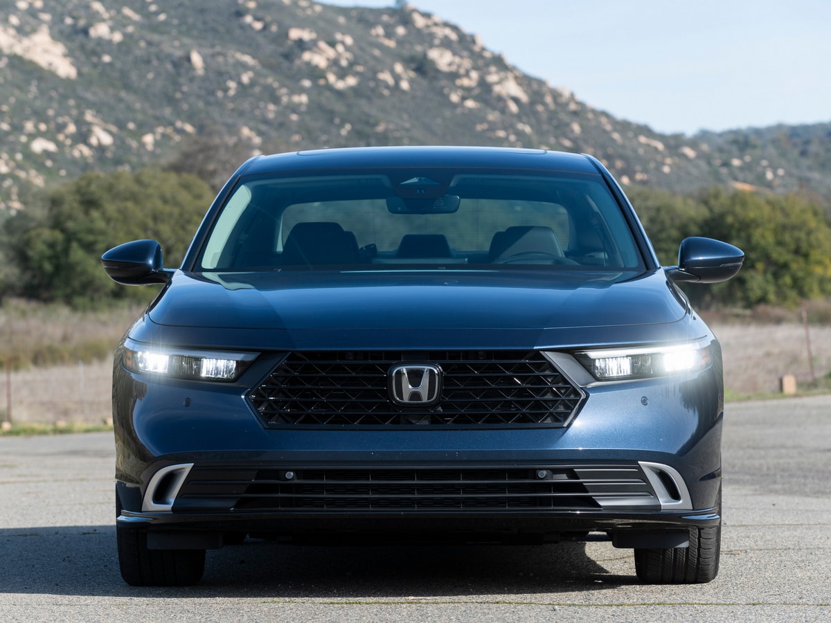 Blue 2023 Honda Accord Hybrid in near rocky hills.