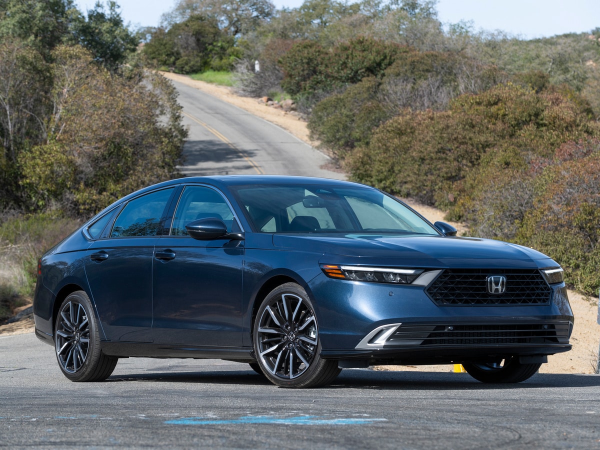 Blue 2023 Honda Accord Hybrid near road.
