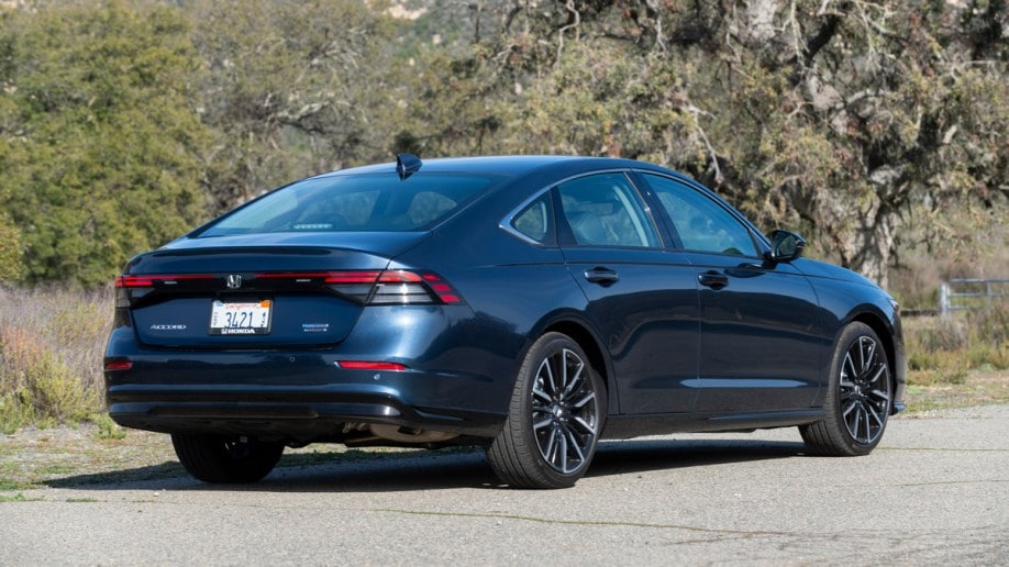 Blue 2023 Honda Accord Hybrid parked near tree.
