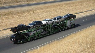 Tractor-trailer car carrier transporting automobiles on a highway
