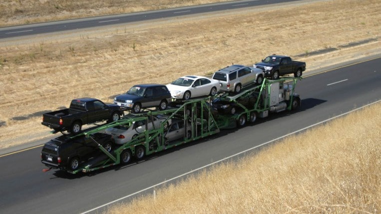 Tractor-trailer car carrier transporting automobiles on a highway