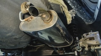 A muffler mounted to a car's undercarriage