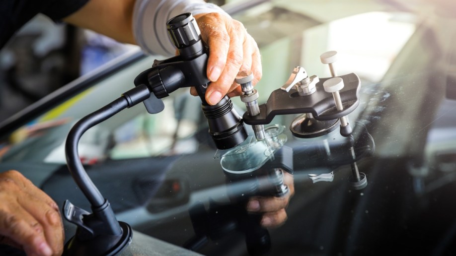 A technician fixing a cracked windshield