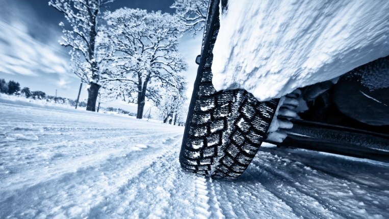 Driving on snowy road in winter tires