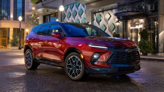 Red 2023 Chevrolet Blazer RS at night on a city street.
