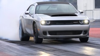 The 2023 Dodge Challenger SRT Demon 170 seen from a front quarter angle, laying down tire smoke, as it should.