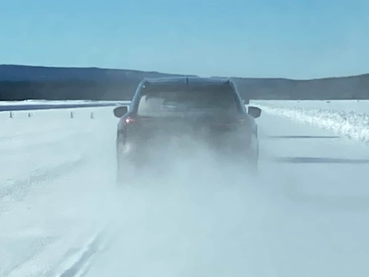 2023 Infiniti QX60 rear view on snow course.
