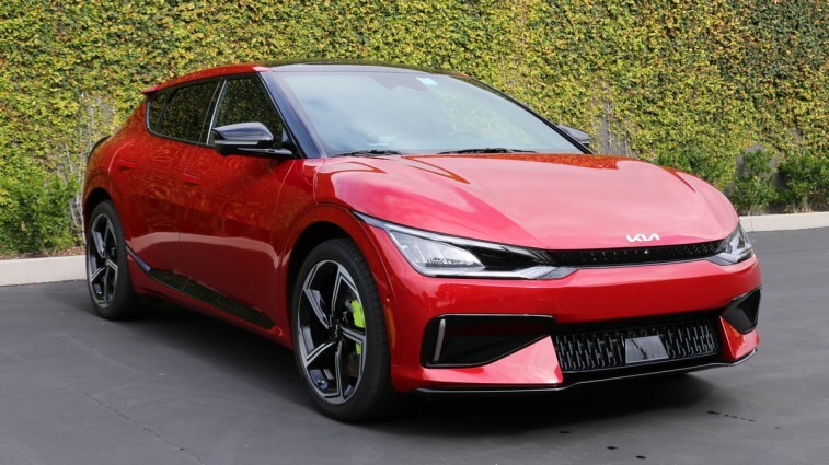 Red 2023 Kia EV6 GT near green wall.
