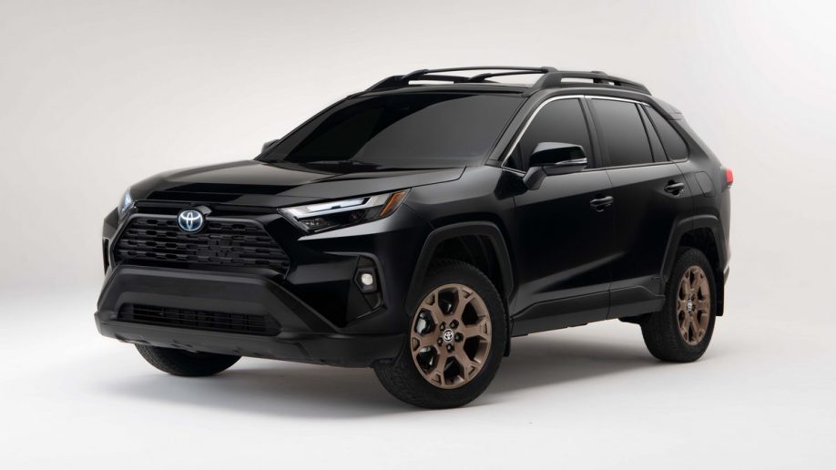 Black 2023 Toyota RAV4 Hybrid Woodland Edition in studio.