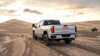 The 2024 GMC Sierra HD on a sand trail.