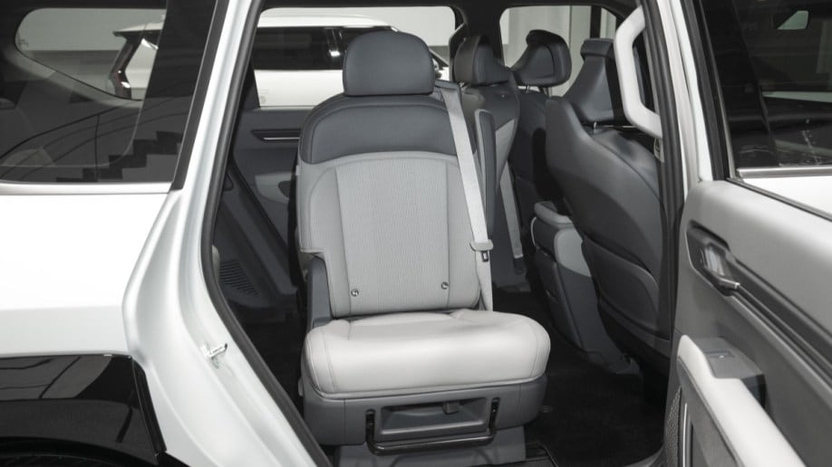 The second-row seats of the 2024 Kia EV9, swiveled to face out the open doors