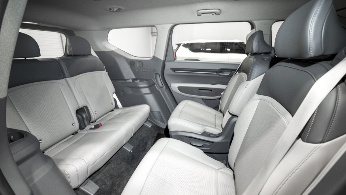 The seats of the 2024 EV9, with the second row swiveled to face the rear