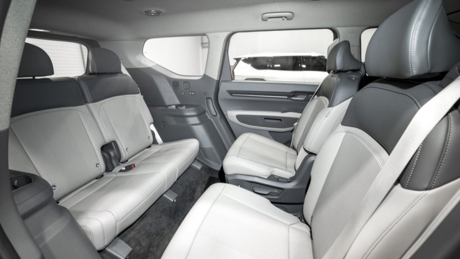 The seats of the 2024 EV9, with the second row swiveled to face the rear