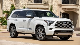 2024 Toyota Sequoia in white, parked near a building.