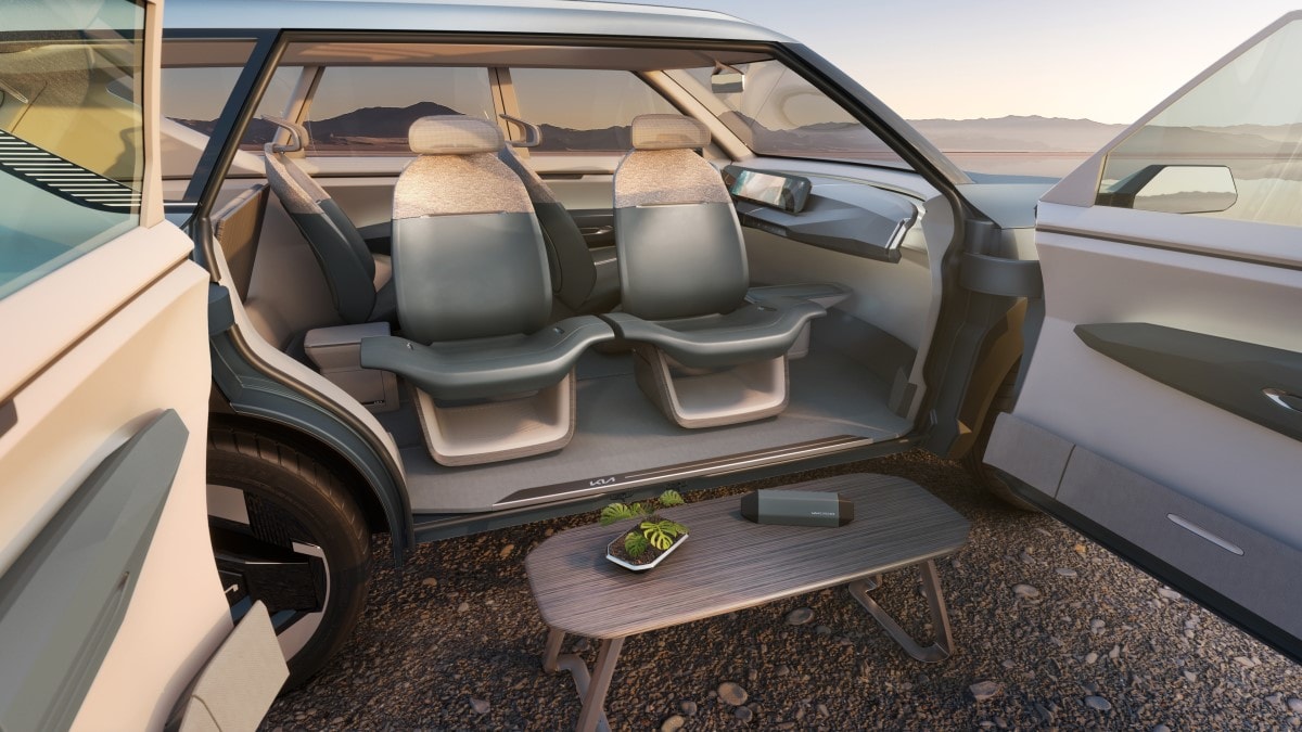 The Kia EV5 Concept with its coach-style doors open and seats facing out
