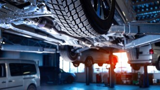 Cars on lifts in a service bay