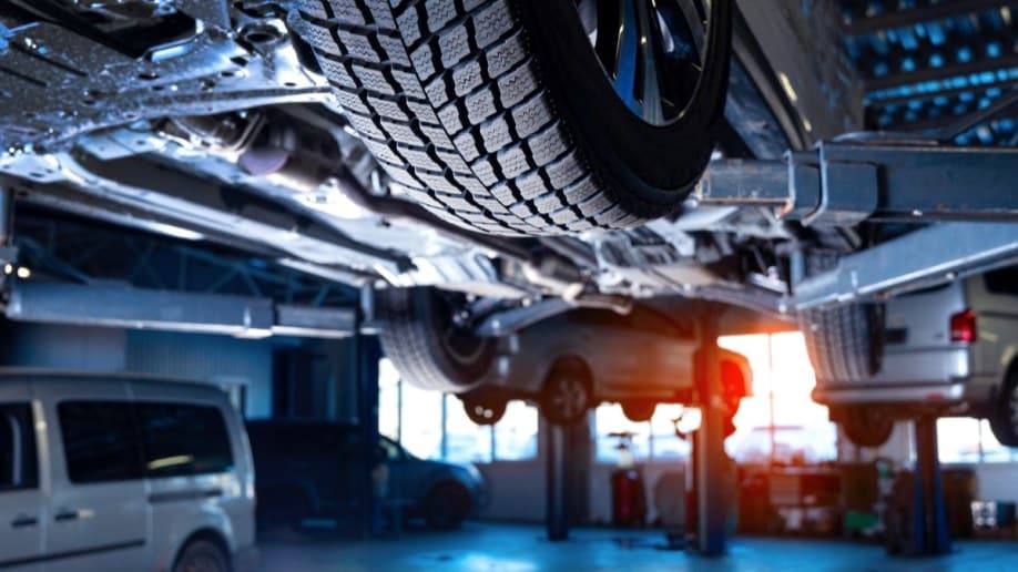 Cars on lifts in a service bay