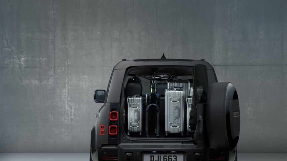 The 2024 Defender 130 Outbound seen from the rear with its cargo area loaded