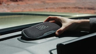 A teaser photo showing a removable Bluetooth speaker in the dashboard of the 2024 Toyota Tacoma