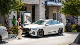 A customer charges at a Volta destination charger