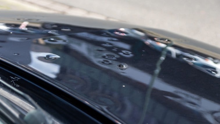 Dents from hail damage on a car hood