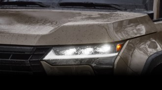 A teaser photo showing one headlight of the upcoming 2024 Lexus GX