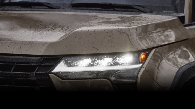 A teaser photo showing one headlight of the upcoming 2024 Lexus GX