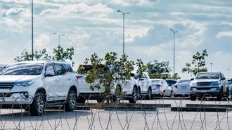 New cars behind barbed wire