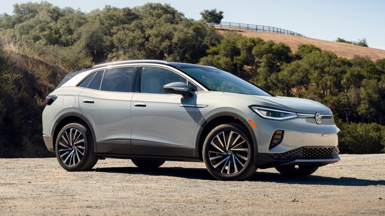 2023 Volkswagen ID.4 in silver parked on gravel with trees in the background.