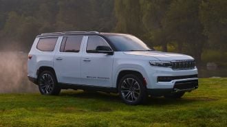 2024 Grand Wagoneer in white parked on grass.