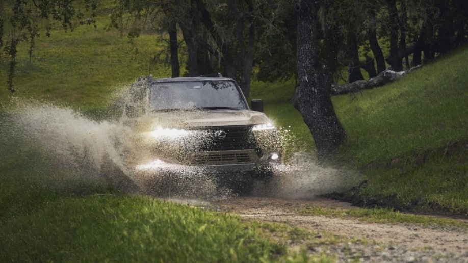 The 2024 Lexus GX splashes through a puddle