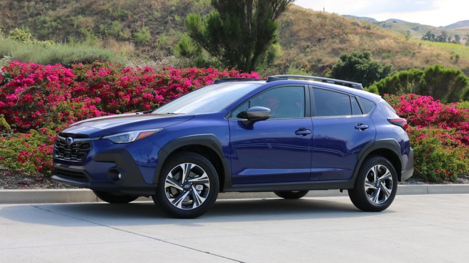 2024 Subaru Crosstrek in blue with bougainvillea in background.