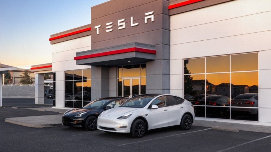 A Tesla Model Y and Model 3 sit outside a sales center