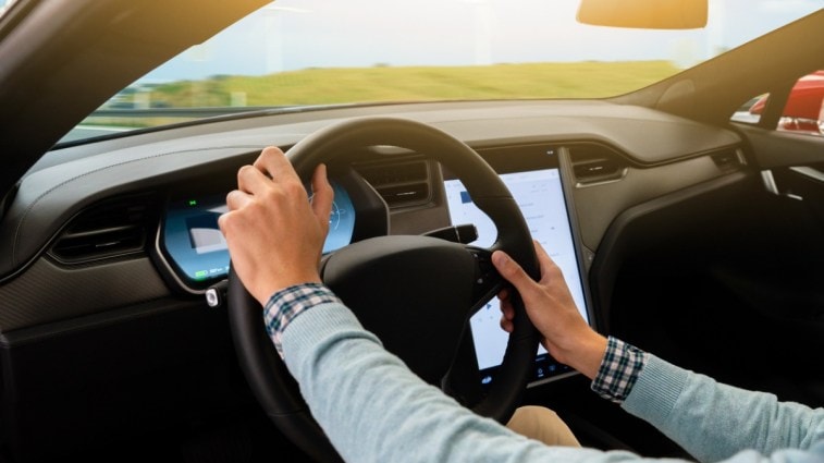 A person driving an electric car