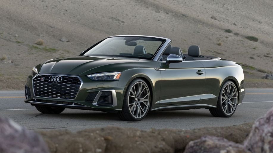 2023 Audi S5 cabrio in green near dunes at sunset.