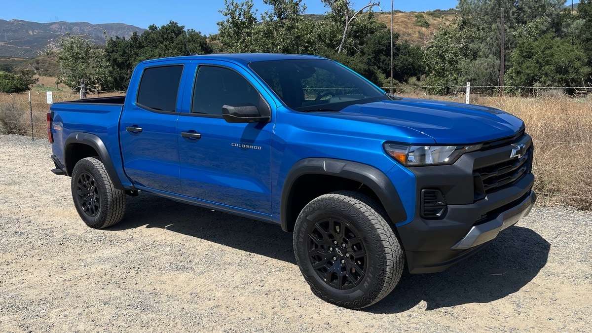 2023 Chevrolet Colorado Trail Boss in blue with trees in the background.