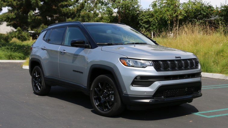 2023 Jeep Compass Altitude in silver near grass.