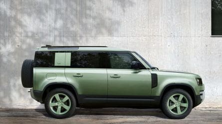 2023 Land Rover Defender 110 75th Edition in green next to a wall.