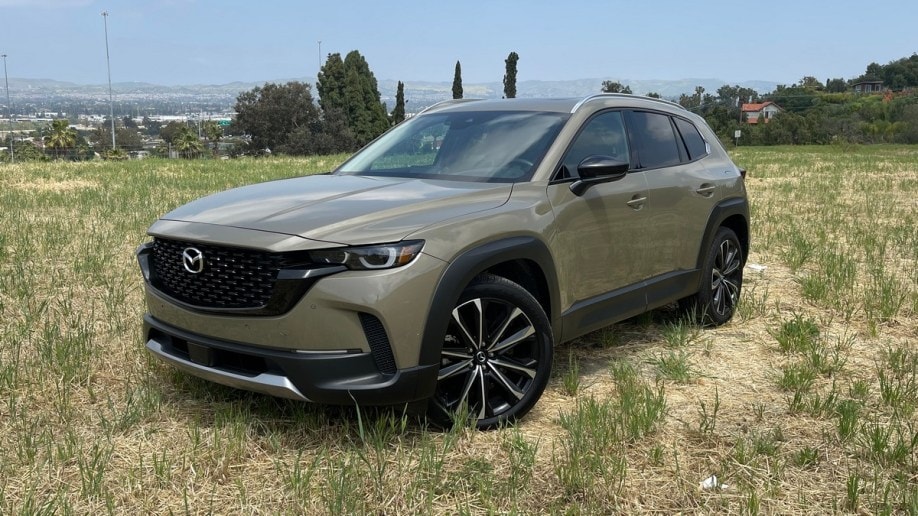 2023 Mazda CX-50 in tan parked in a dirt field.